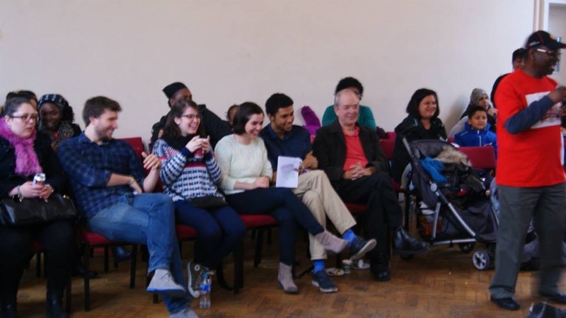 Members of the congregation seated together in the church hall