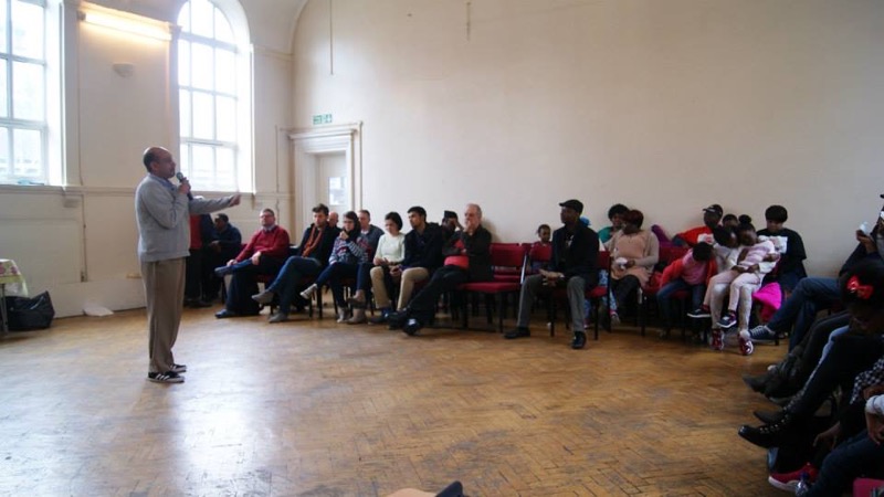 The congregation seated in the hall as a speaker addresses them