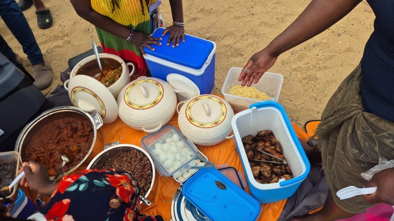 A shared picnic of home-cooked food on the beach