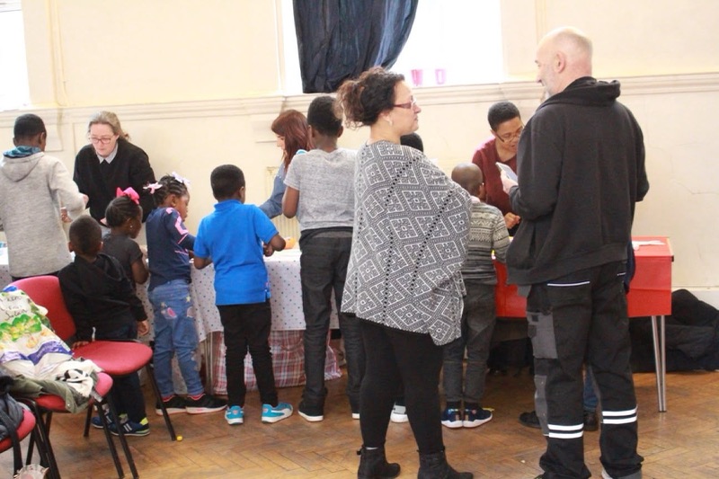 Guests and volunteers, young and old, gathered in the hall at the Easter Charity Event