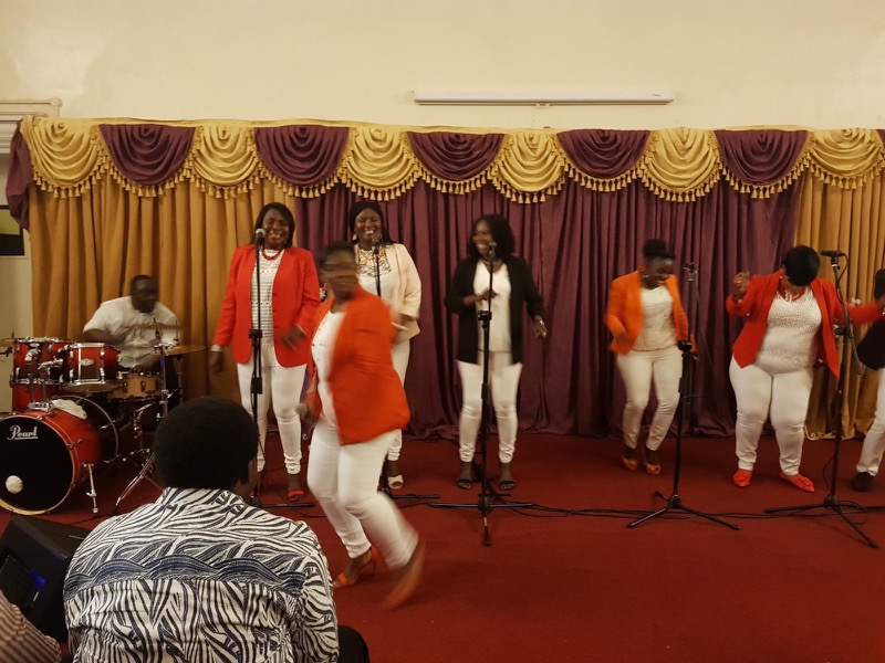 Singers in red and white leading worship on stage at Just Worship 2018